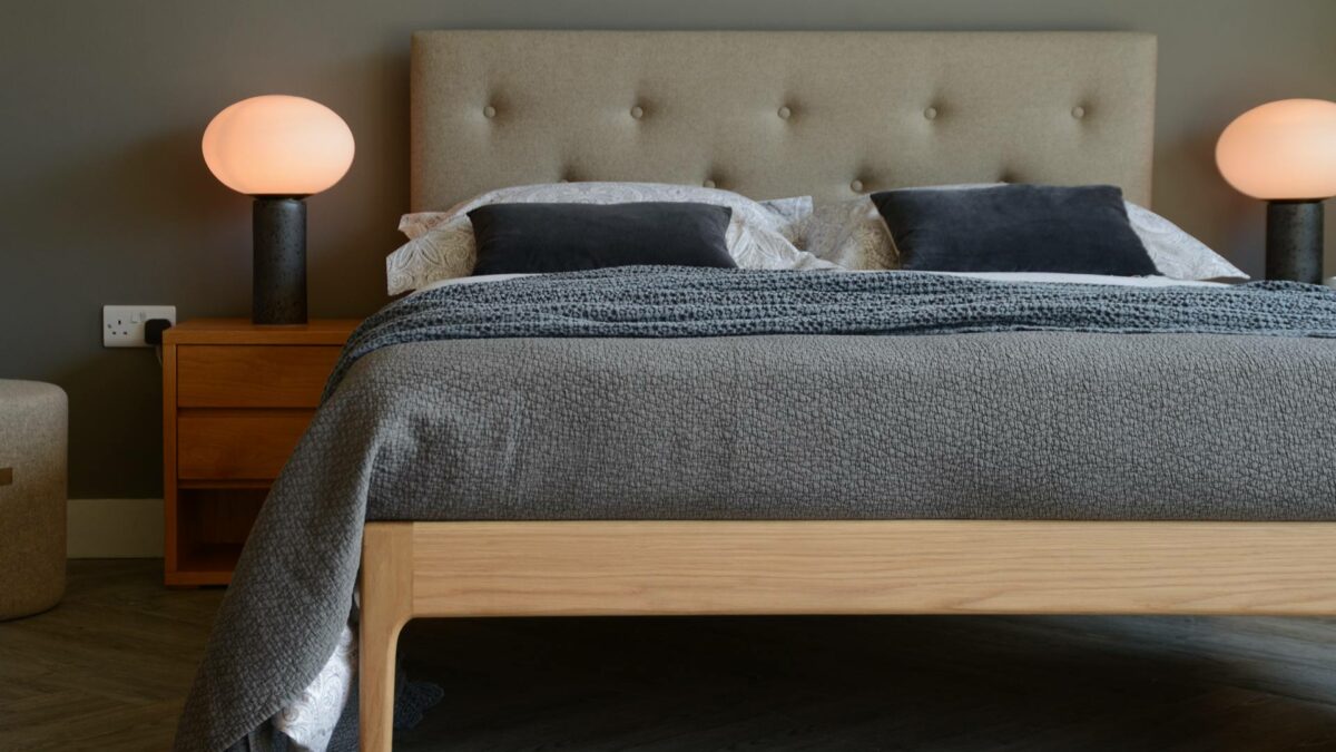 Mid-century style wooden bed with upholstered headboard