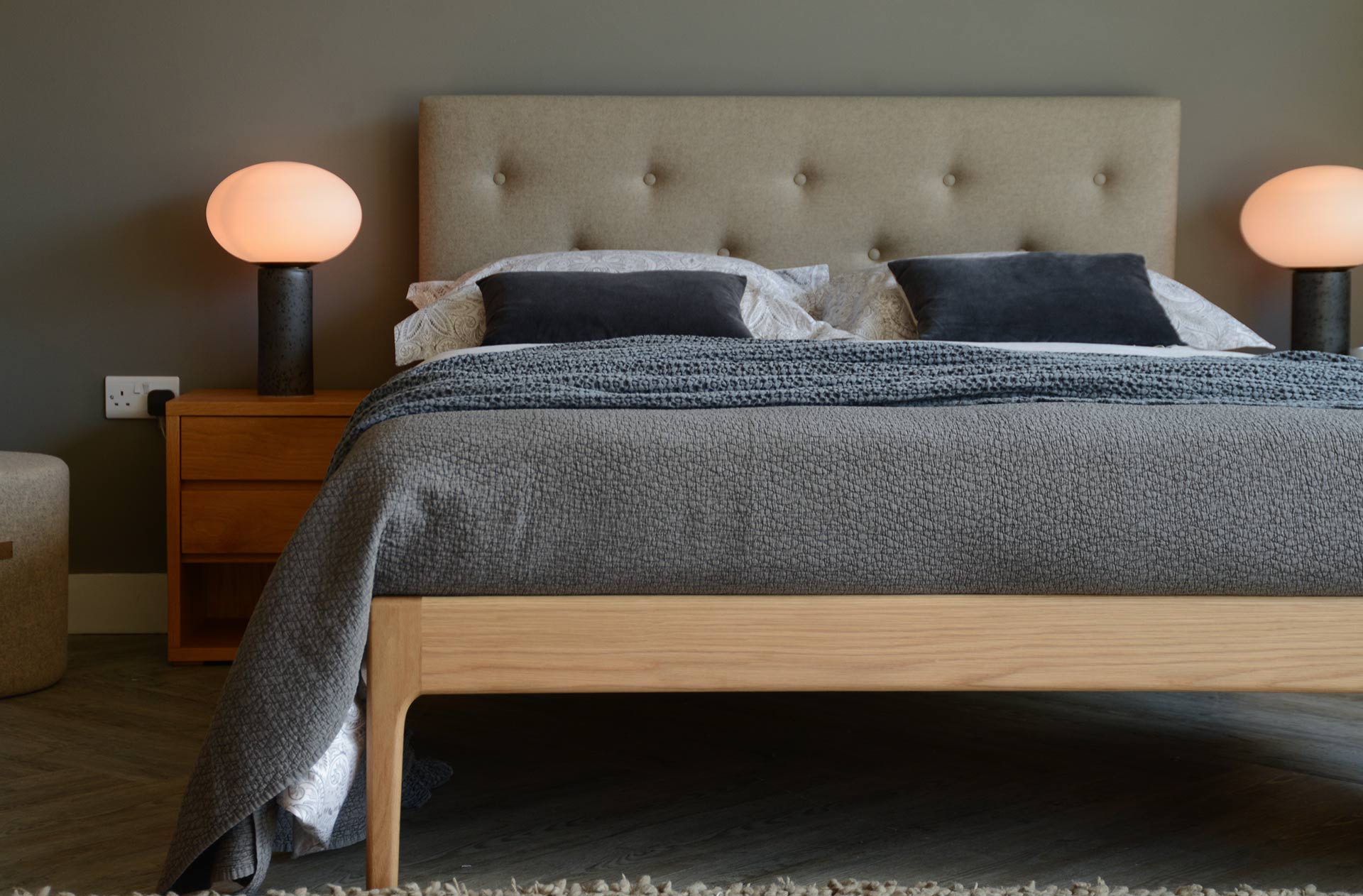 Mid-century style wooden bed with upholstered headboard