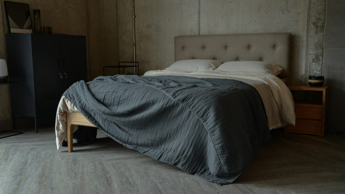 Nordic style bedroom with moody colours and an upholstered headboard wooden Bloomsbury bed