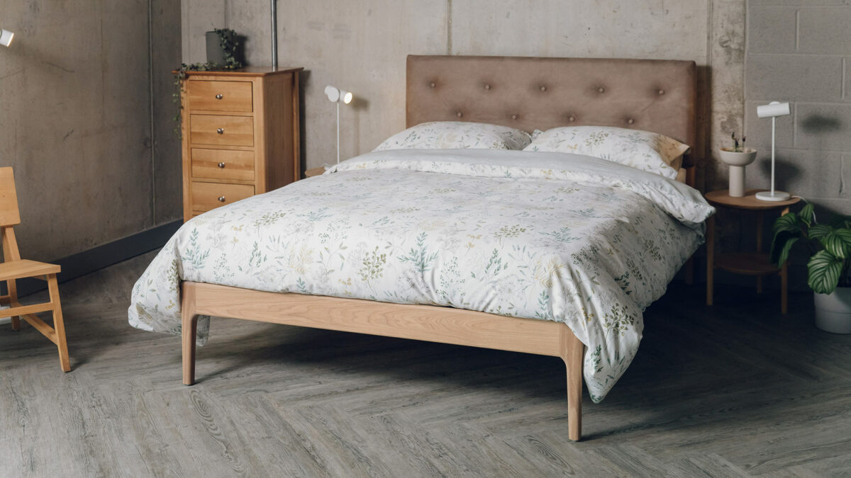 Oak Bloomsbury bed with oiled frame and a headboard upholstered in a faux leather