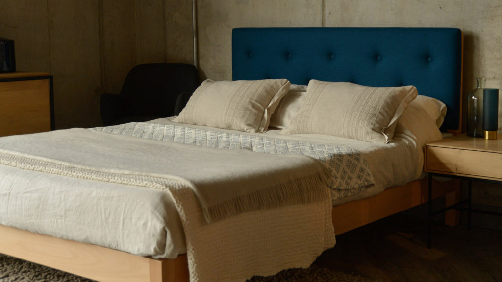 this Beech Arran bed has an upholstered headboard covered in Teal Blue wool felt