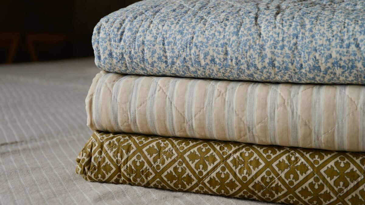 blue and cream printed quilts stack