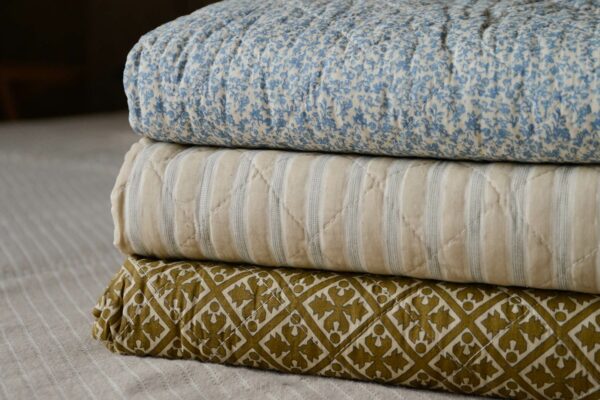 blue and cream printed quilts stack