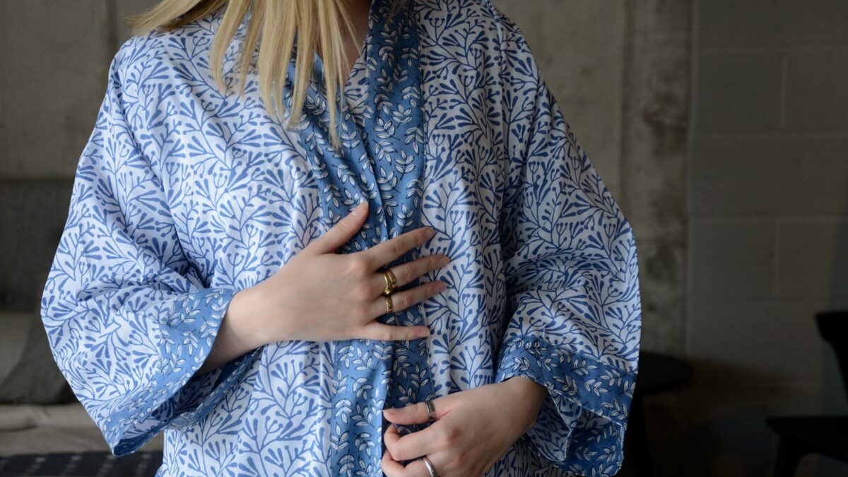 lightweight white cotton robe with a block print leaf design in blue and with contrast belt and cuffs