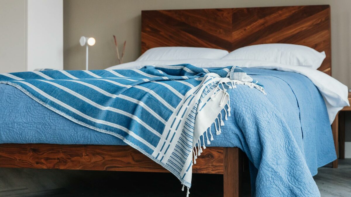 blue bedding on walnut bed