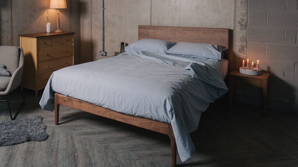 Pale blue Chambray bedding including sheets, pillowcases and duvet covers shown on a kingsize walnut bed