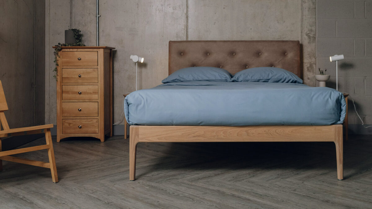 Oak Bloomsbury bed with oiled frame and a headboard upholstered in a faux leather