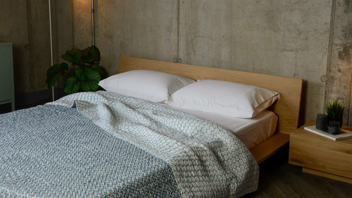 blue handmade reversible printed quilt on oak oregon