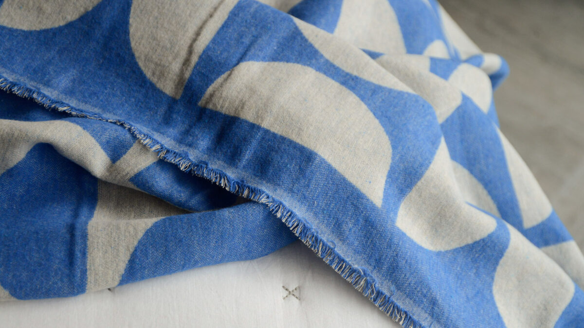 graphic patterned soft cotton throws in blue and ecru