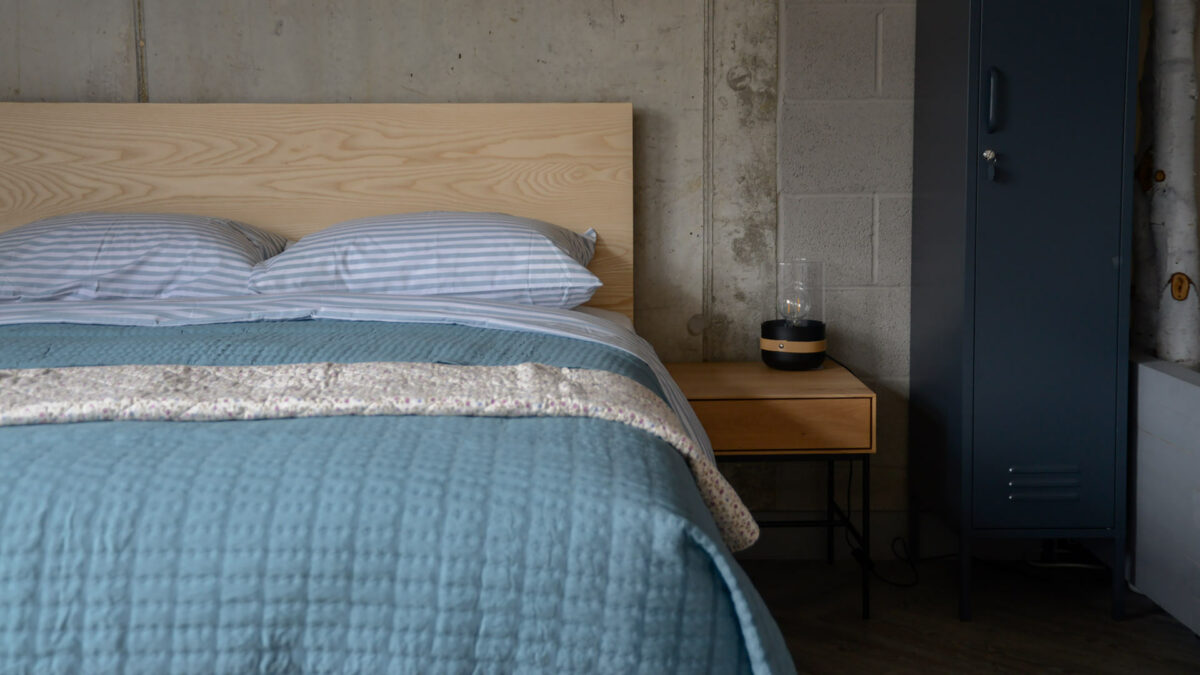 blue quilt on ash bed
