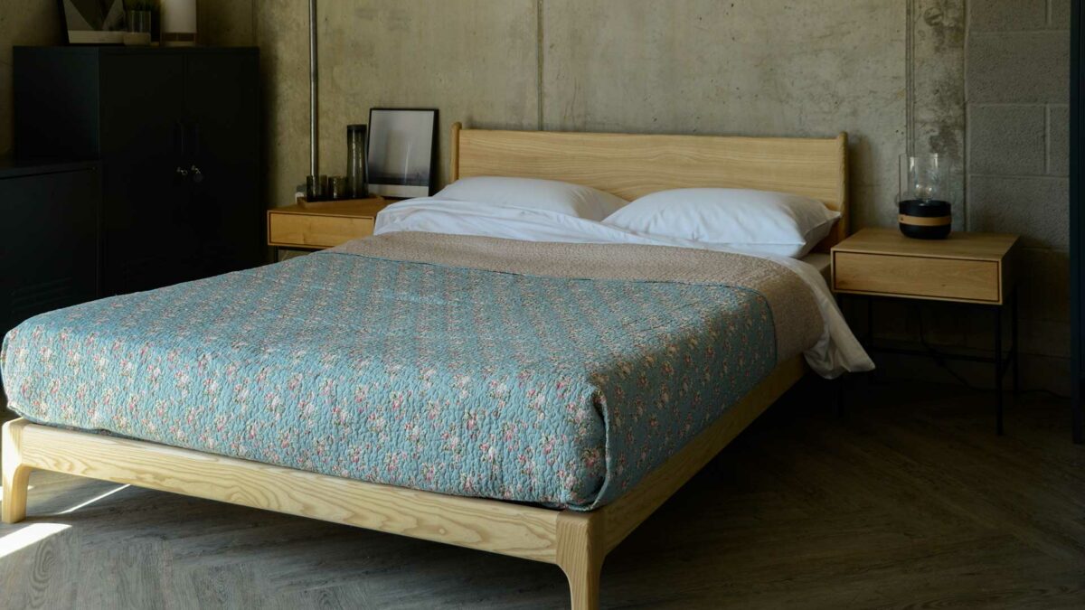 Vintage look pale blue patterned bedspread on solid wood Carnaby bed