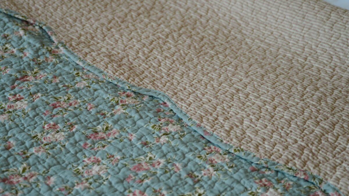 blue vintage look bedspread with pink stripe reverse detail
