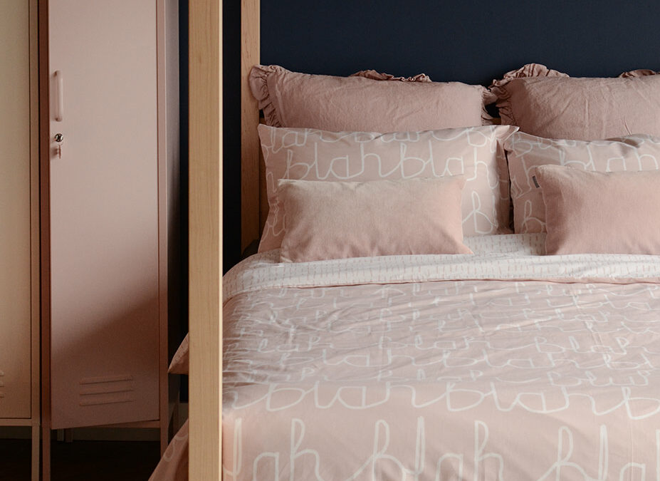 Our Orchid 4 poster wooden bed shown with blush pink bedding