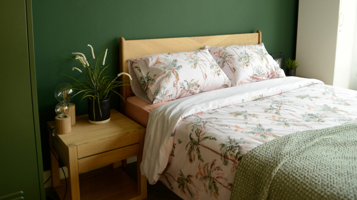 blush pink and green decor - palm print bedding on an Oak Hoxton bed