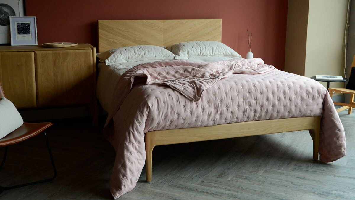blush pink soft cross stitch bedspread on oak highbury