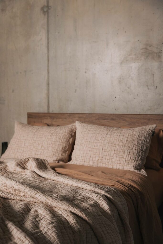 textured bedspread and pillowcase set in Blush pink shown on a kingsize bed