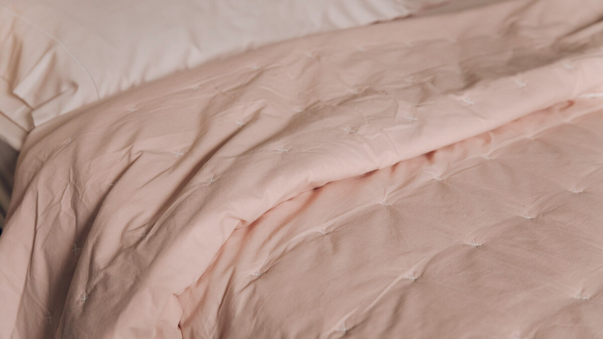 blush pink quilted cotton bedspread shown in close up