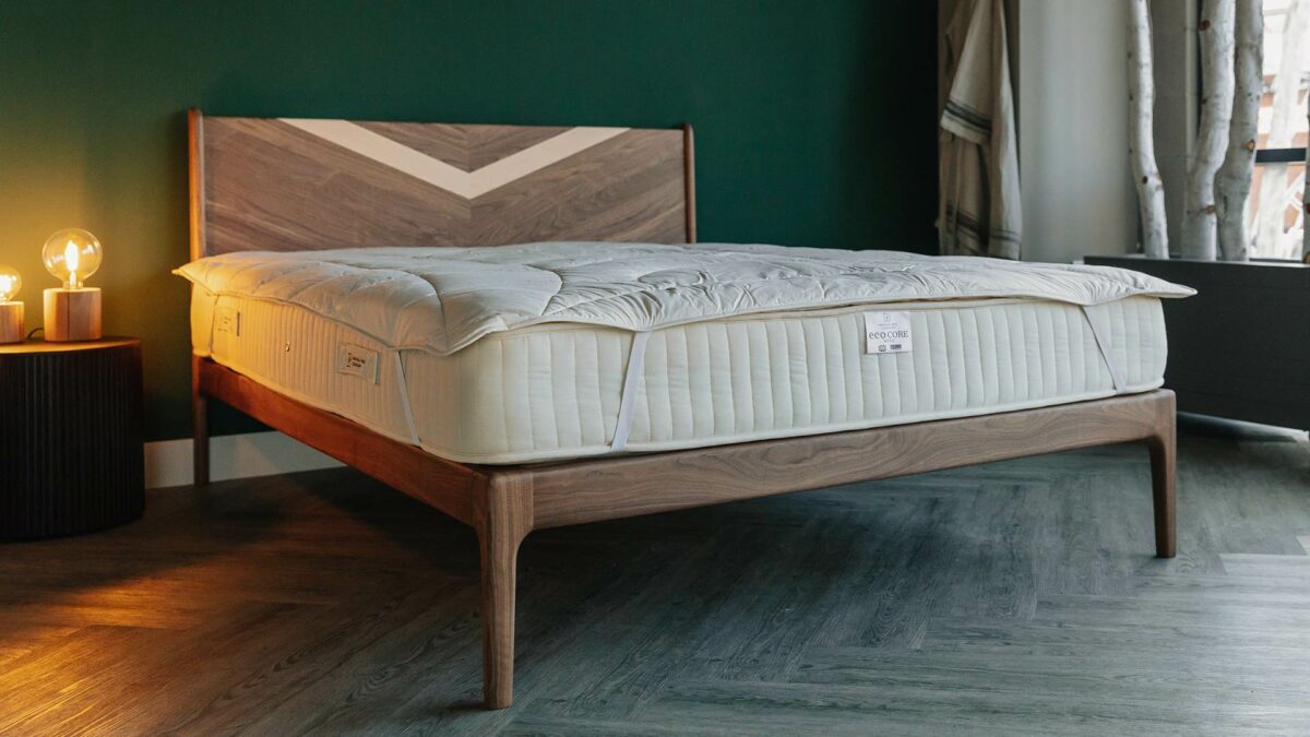 organic wool filled cosy mattress covers shown on a hand made walnut Hoxton bed frame