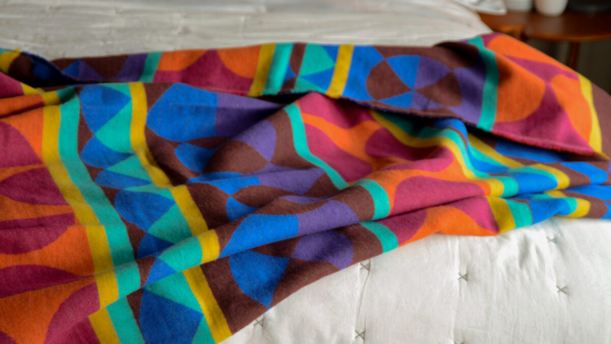 bright and bold patterned throw in rainbow colours