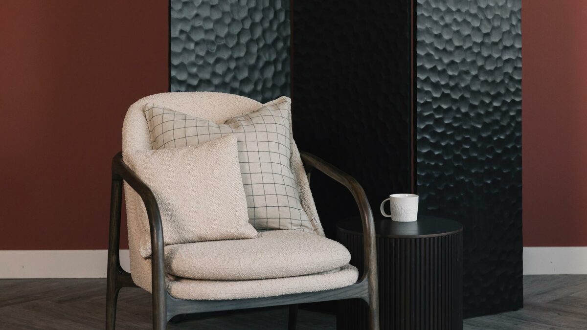 boucle chair with screen roller side table and porcelain mug
