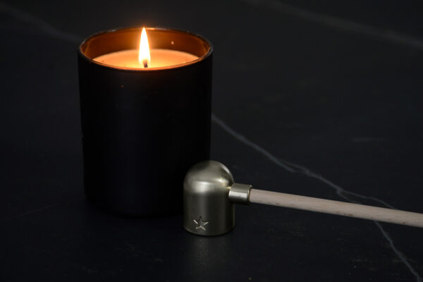 modern candle snuffer with a wooden handle