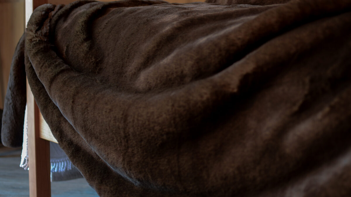 brown bear faux fur bedspread draped