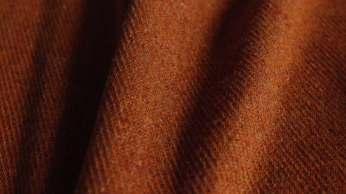 close up of burnt orange merino throw.