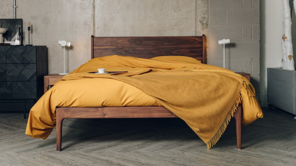 camden bed in walnut with oiled finish and ochre bedding