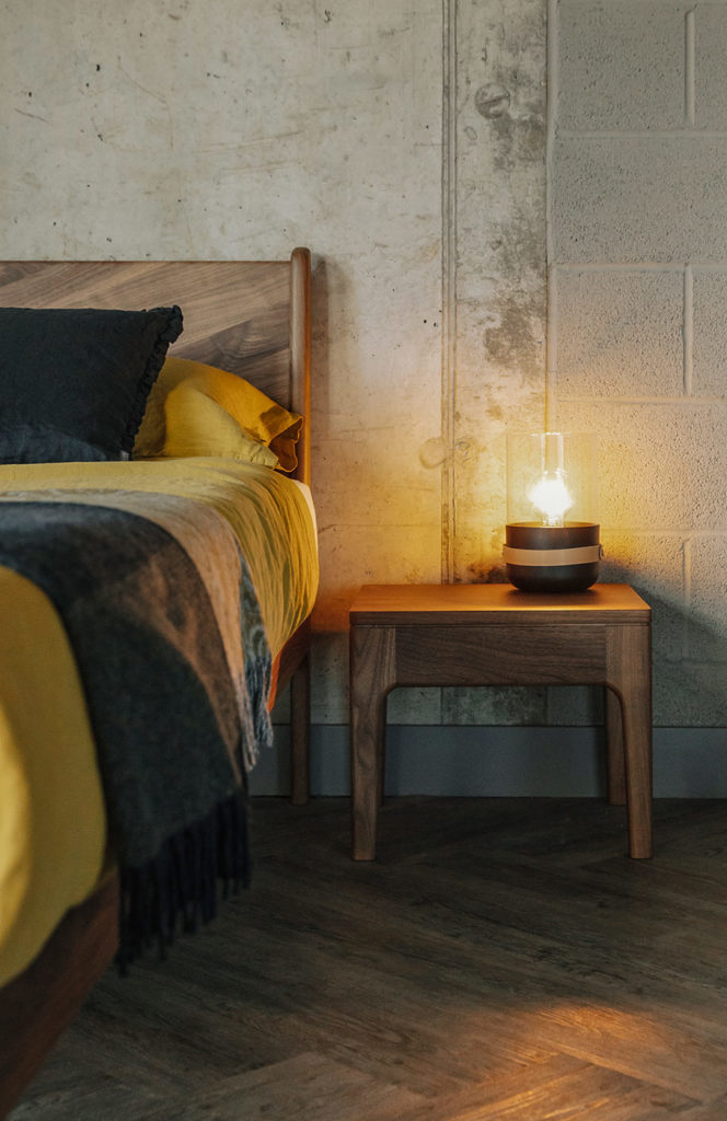 Camden solid wooden table shown with our Walnut Hoxton bed