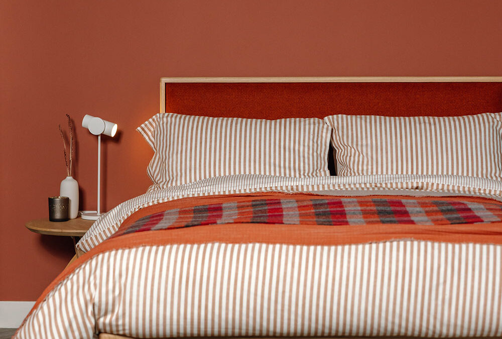 carlile bed with rust red bedding portrait