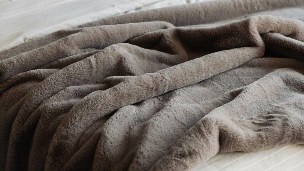 Softest luxury faux fur bedspread in cement grey