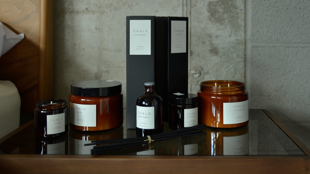 scented candles and diffusers in amber glass jars