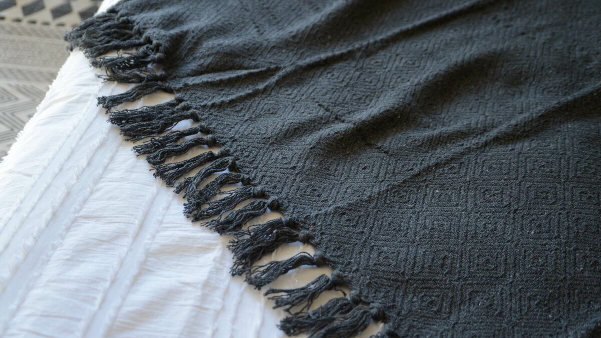 charcoal grey diamond weave cotton throw with fronted edge shown close up