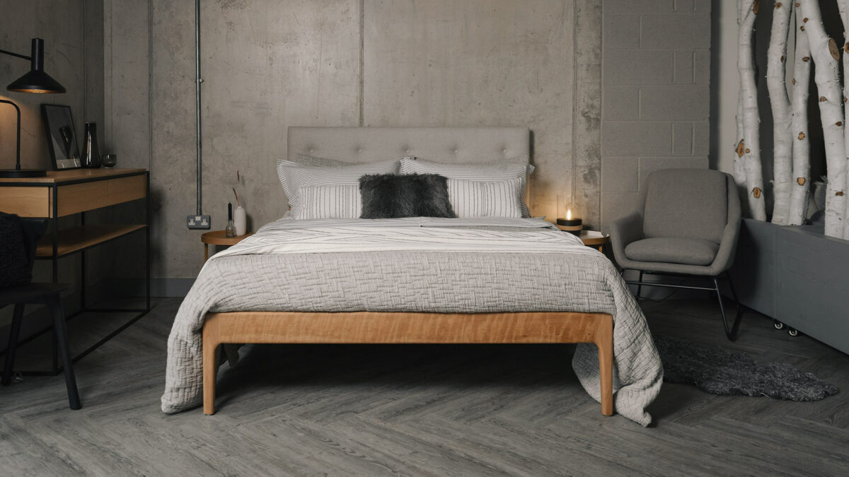 loft style bedroom featuring upholstered Bloomsbury bed with a cherry base