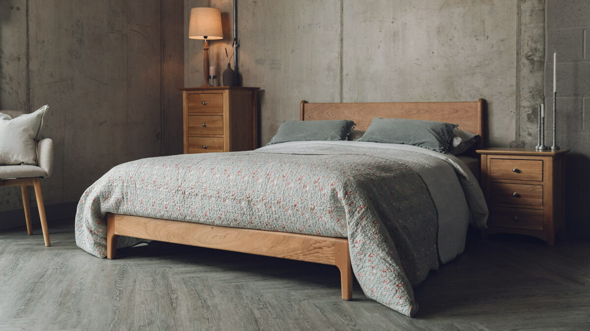 Cottage chic bedroom with a Carnaby mid century style low bed and oak chests of drawers