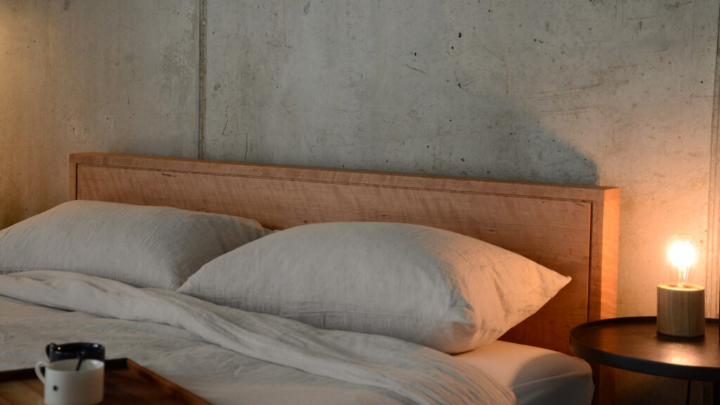 Leith bed headboard in solid cherry wood with a rippled grain