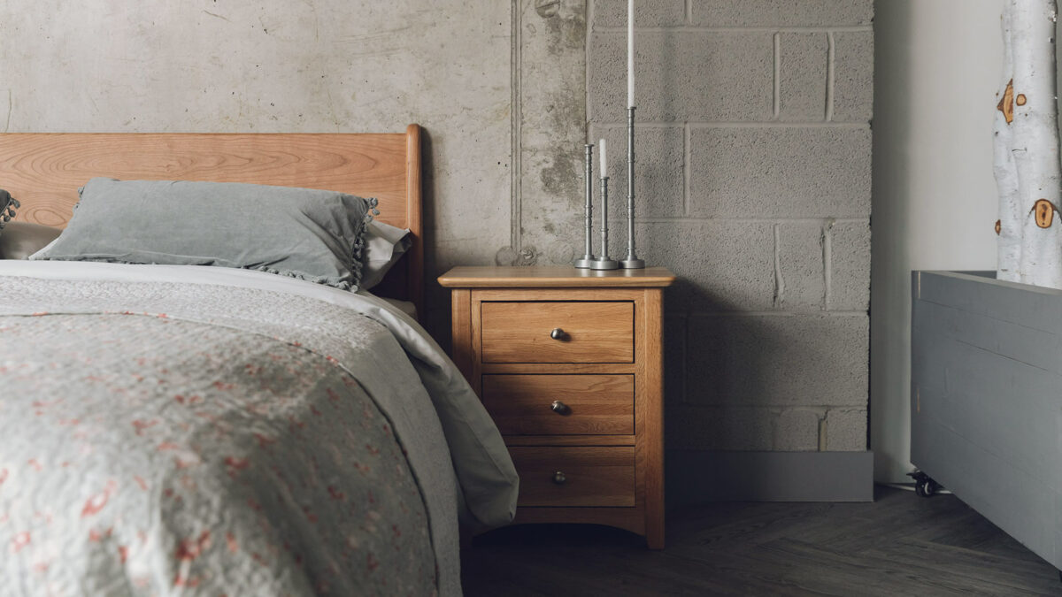 classic style oak bedroom storage chest with 3 drawers here used as a bedside table