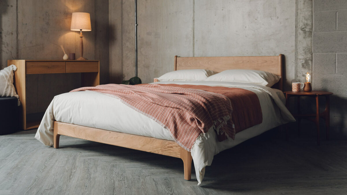 Carnaby a low mid century style bed frame here made in solid cherry wood