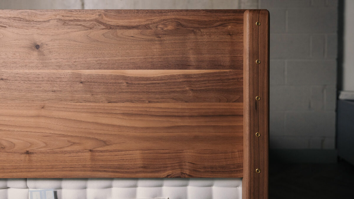 a view of the reverse of the headboard of a walnut wood Chiswick bed