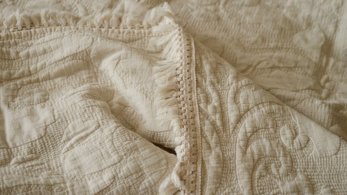 classic embroidered throw warm stone