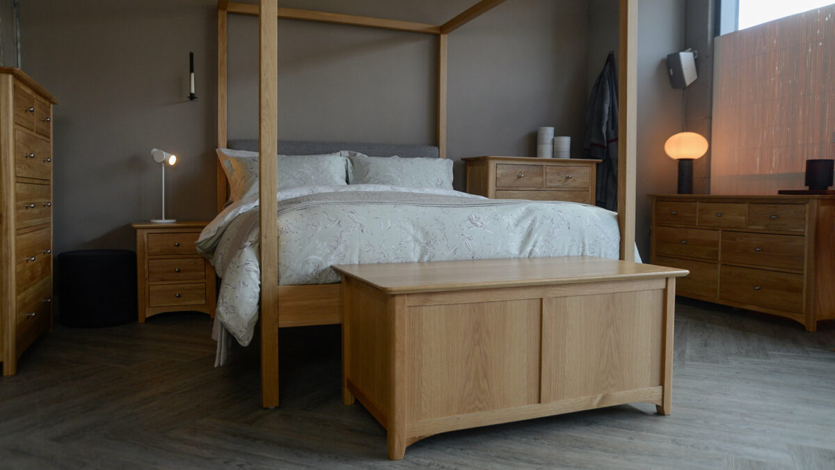 Oak Highland 4 poster bed shown with classic oak storage furniture