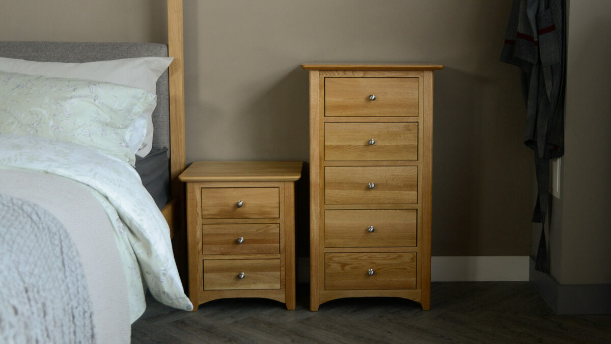 classic oak bedroom storage in 3 and 5 drawer options shown next to a bed