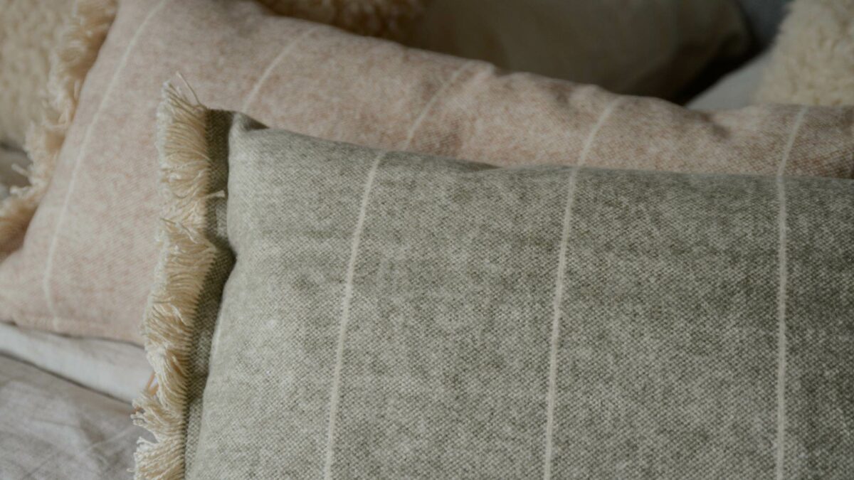 soft touch rectangular cushions in a choice of sage green or rust red and cream