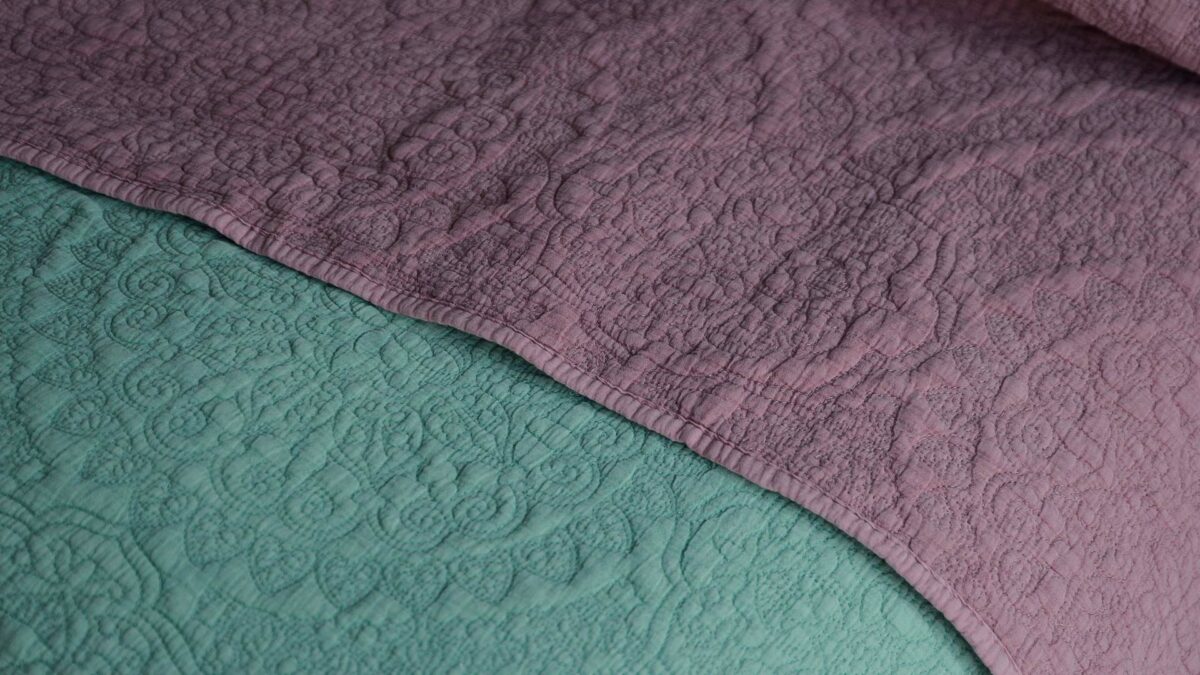 floral embroidered quilted bedspreads in sage green and dusky pink