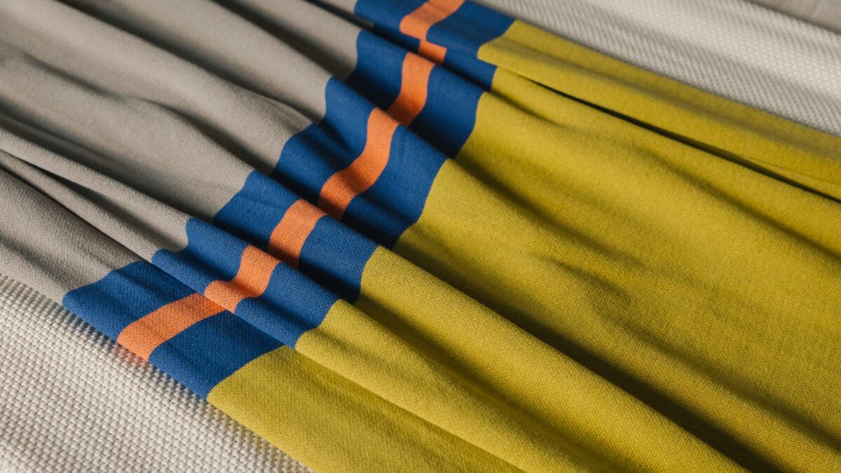 colour block throw in taupe and lime with a central stripe of orange and blue