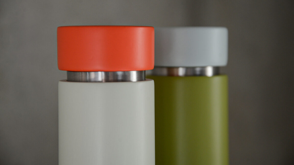 colourful wooden salt and pepper grinder close up orange and grey