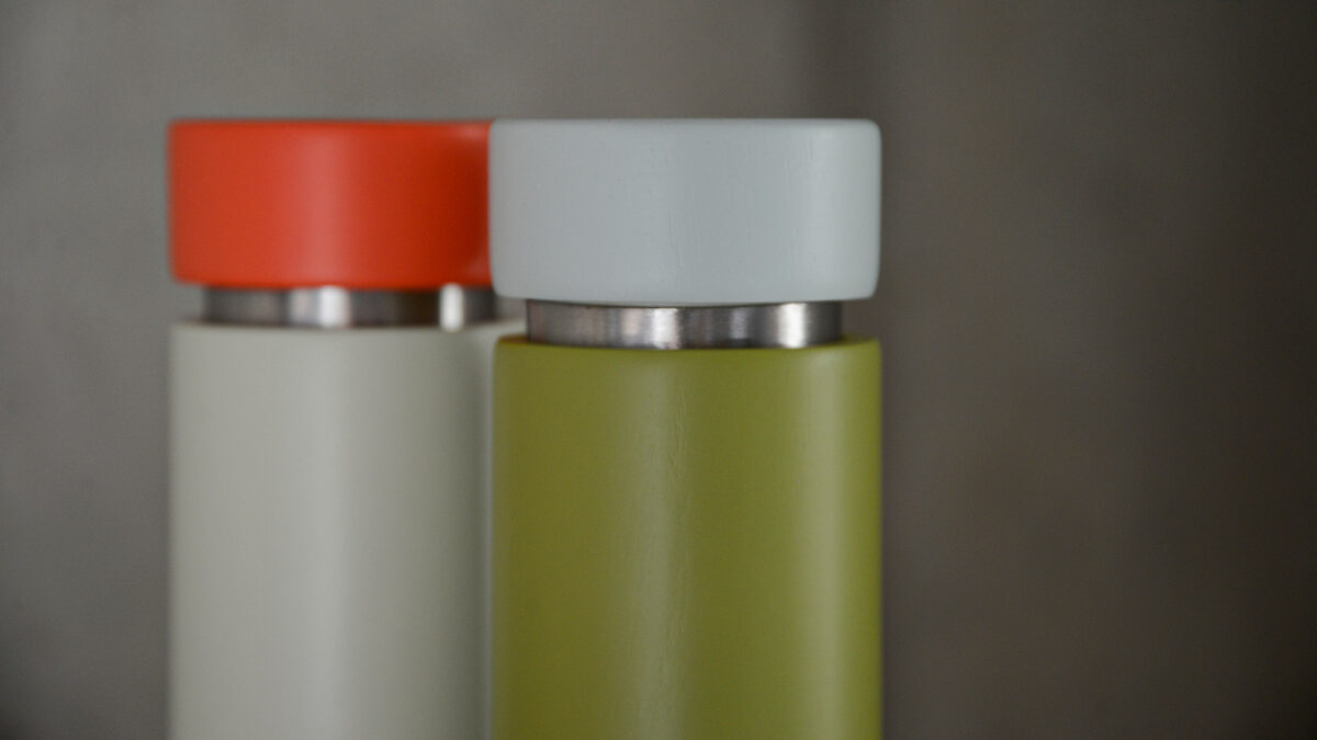 colourful wooden salt and pepper grinders green close up