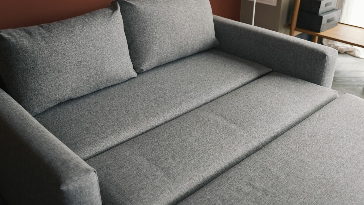 compact sofa bed extended with back cushions