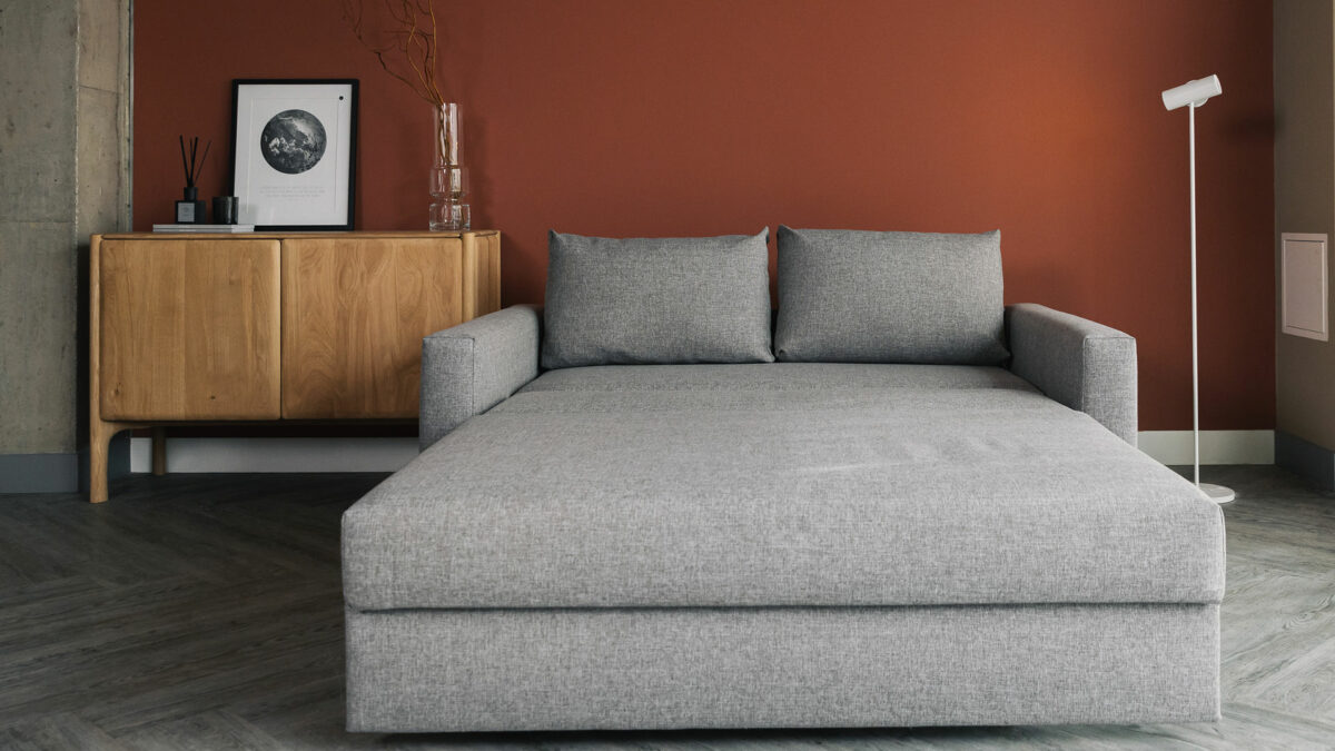 compact sofa bed extended with oak sideboard