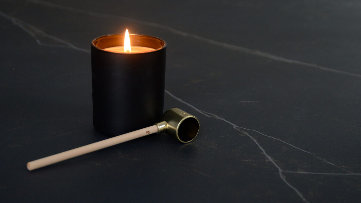 modern candle snuffer with a wooden handle